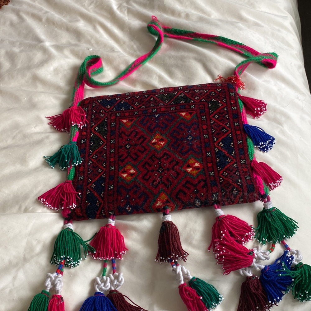 Funky Purse with button closure. Bohemian. Made of a rug like material.
